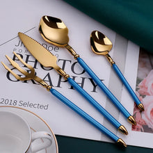 Load image into Gallery viewer, Neptune 4-piece Colored Handle Luxury Flatware Set by Allthingscurated beautifully blends mythical design with modern construction. Made from high-quality 18/10 stainless steel with a sleek mirror polishing for a modern look. Inspired by Poseidon’s Trident, the dinner fork is expertly shaped to resemble the 3-pronged spear. This place setting comes in Gold with either black, white, turquoise blue and green handle. Each set consists of a dinner spoon, dinner fork, dinner knife and a small spoon.