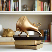 Load image into Gallery viewer, The Oscar Bull Sculpture by Allthingscurated spots an abstract and contemporary design in a matte gold finish. This stunning piece makes the perfect gift for those born under the zodiac ox sign and Taurus. It not only serves as a beautiful display but also adds a touch of personality.