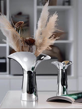 Load image into Gallery viewer, Manhattan Stainless Steel Petal Vase by Allthingscurated combines modern sophistication with minimal elegance. Designed with a petal-shaped rim that opens up up like a blooming flower, it’s a fun yet refined statement piece for any home décor style. Makes a stylish gift for housewarmings. Available in 2 sizes.