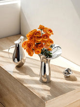 Load image into Gallery viewer, Manhattan Stainless Steel Petal Vase by Allthingscurated combines modern sophistication with minimal elegance. Designed with a petal-shaped rim that opens up up like a blooming flower, it’s a fun yet refined statement piece for any home décor style. Makes a stylish gift for housewarmings. Available in 2 sizes.