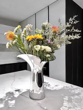 Load image into Gallery viewer, Manhattan Stainless Steel Petal Vase by Allthingscurated combines modern sophistication with minimal elegance. Designed with a petal-shaped rim that opens up up like a blooming flower, it’s a fun yet refined statement piece for any home décor style. Makes a stylish gift for housewarmings. Available in 2 sizes.