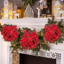 Load image into Gallery viewer, Decorative poinsettia garland on a fireplace mantel. Bring the true spirit of the holidays into your home with this bundle of 5 classic red Faux Poinsettia by Allthingscurated. These timeless blooms complement any festive palette and instantly evokes Christmas cheer.
