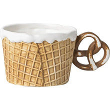 Load image into Gallery viewer, The Waffle Cup and Plate collection by Allthingscurated features a charming waffle pattern and whimsical biscuit design that will bring a smile to your breakfast. Each piece is hand painted on porcelain. Perfect for breakfast and tea time. Makes a great gift for any occasion. Cup and plate each comes in 4 designs to choose from. Featured here is cup with pretzel handle in honey.