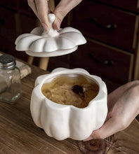 Load image into Gallery viewer, Lidded Stoneware Pumpkin Bowl by Allthingscurated features a sculptural pumpkin design.  It has a matte glaze finish in creamy white. Holds a capacity of 450mil or 15 ounce. Oozing with autumnal charm, it's the perfect serving bowl for all your thanksgiving, halloween and fall feasts.