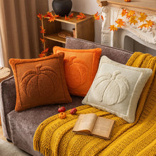 Load image into Gallery viewer, Cozy living room with a sofa adorned with pumpkin-themed pillows and a yellow blanket. The Velour Pumpkin Cushion Cover by Allthingscurated is a beautiful way to bring the warmth of fall into your home. With its elegant tufted pumpkin design and soft velour fabric, it offers both comfort and style. Perfect for autumn and Thanksgiving, this decorative pillow adds a cozy, inviting touch to any space.