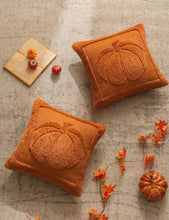 Load image into Gallery viewer, Two orange pumpkin-shaped cushions on a textured surface with decorative elements. Cozy living room with a sofa adorned with pumpkin-themed pillows and a yellow blanket. The Velour Pumpkin Cushion Cover by Allthingscurated is a beautiful way to bring the warmth of fall into your home. With its elegant tufted pumpkin design and soft velour fabric, it offers both comfort and style. Perfect for autumn and Thanksgiving, this decorative pillow adds a cozy, inviting touch to any space.