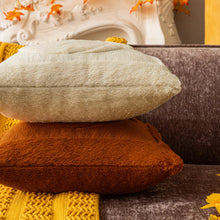 Load image into Gallery viewer, Stack of textured pillows in various colors on a sofa. Cozy living room with a sofa adorned with pumpkin-themed pillows and a yellow blanket. The Velour Pumpkin Cushion Cover by Allthingscurated is a beautiful way to bring the warmth of fall into your home. With its elegant tufted pumpkin design and soft velour fabric, it offers both comfort and style. Perfect for autumn and Thanksgiving, this decorative pillow adds a cozy, inviting touch to any space.
