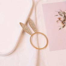 Load image into Gallery viewer, These sparkling Bunny Ear Napkin Rings (set of 6) by Allthingscurated add a cute and whimsical touch to your Easter table setting. Made of metal and encrusted with rhinestones, they come in gold, silver, and rose gold. Elevate your dining experience with these charming and sparkly napkin rings.