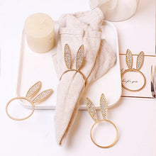 Load image into Gallery viewer, These sparkling Bunny Ear Napkin Rings (set of 6) by Allthingscurated add a cute and whimsical touch to your Easter table setting. Made of metal and encrusted with rhinestones, they come in gold, silver, and rose gold. Elevate your dining experience with these charming and sparkly napkin rings.
