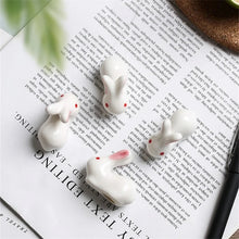 Load image into Gallery viewer, Enhance your Asian dining experience with our Ceramic Rabbit Chopstick Rests by Allthingscurated. These pieces will bring a playful edge to your table with their ability to keep your chopsticks clean and secure. Comes in a set of 3 or 6 pieces.