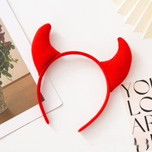 Load image into Gallery viewer, Horn Shape Headband by Allthingscurated features trendy, three-dimensional horns that is fun and perfect for elevating your Halloween party look. This accessory is perfect for adding a playful touch to your costume and make a statement at any Halloween party. Comes in 3 colors. Featured here is the Red headband.