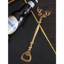 Load image into Gallery viewer, Brass Reindeer Bottle Opener by Allthingscurated. Crafted from brass and designed with a long handle and an ornamental reindeer head—it is an eye-catching bar tool and charming accessory for Christmas and beyond.