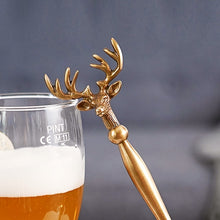 Load image into Gallery viewer, Brass Reindeer Bottle Opener by Allthingscurated. Crafted from brass and designed with a long handle and an ornamental reindeer head—it is an eye-catching bar tool and charming accessory for Christmas and beyond.