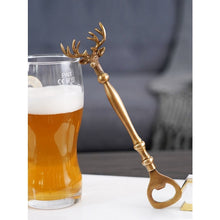 Load image into Gallery viewer, Brass Reindeer Bottle Opener by Allthingscurated. Crafted from brass and designed with a long handle and an ornamental reindeer head—it is an eye-catching bar tool and charming accessory for Christmas and beyond.