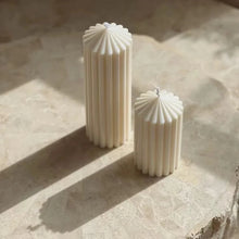 Load image into Gallery viewer, White Ribbed Column Candles by Allthingscurated are made of 100% soy wax. Hand crafted with vertical ridged pattern for texture, these candles are scented with the sweet smell of white rose. Available in 2 sizes.