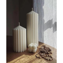Load image into Gallery viewer, White Ribbed Column Candles by Allthingscurated are made of 100% soy wax. Hand crafted with vertical ridged pattern for texture, these candles are scented with the sweet smell of white rose. Available in 2 sizes.