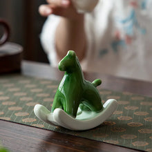Load image into Gallery viewer, This Petite Ceramic Rocking Horse by Allthingscurated is a work of art. Crafted by hand from ceramic and decorated with a beautiful crackle pattern, it exudes a subtle far-eastern beauty and grace. Makes a perfect gift for those who appreciate quality craftsmanship and a treasured gift to any horse collector. Comes in green and azurerish white. Measures 9.8cm or 3.8 inches in height, 10.4cm or 4 inches in width and 4.2cm or 1.6 inches in depth.