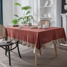 Load image into Gallery viewer, Introducing Ruffled Cotton Tablecloth by Allthingscurated. Made from 100% cotton, our tablecloth exudes French country charm with its romantic, frilly ruffles. With the perfect balance of decorative and laid-back, they have a welcoming and comforting vibe. Available in 8 solid colors. Featured here is the Rust Beige color.