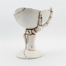 Load image into Gallery viewer, Gothic Skeleton Hand Storage Bowl by Allthingscurated boasts a spooky design featuring a ghoulish skeleton claw in neutral warm off-white and vivid hand bones encircling the bowl. Perfect for adding a frightful touch to your Halloween decor. Crafted from resin and measuring height of 13.5m or5.3 inches and width of 12cm or 4.7 inches.