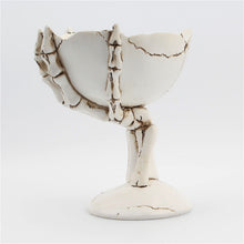 Load image into Gallery viewer, Gothic Skeleton Hand Storage Bowl by Allthingscurated boasts a spooky design featuring a ghoulish skeleton claw in neutral warm off-white and vivid hand bones encircling the bowl. Perfect for adding a frightful touch to your Halloween decor. Crafted from resin and measuring height of 13.5m or5.3 inches and width of 12cm or 4.7 inches.