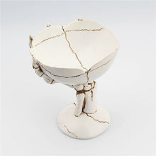 Load image into Gallery viewer, Gothic Skeleton Hand Storage Bowl by Allthingscurated boasts a spooky design featuring a ghoulish skeleton claw in neutral warm off-white and vivid hand bones encircling the bowl. Perfect for adding a frightful touch to your Halloween decor. Crafted from resin and measuring height of 13.5m or5.3 inches and width of 12cm or 4.7 inches.