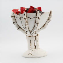 Load image into Gallery viewer, Gothic Skeleton Hand Storage Bowl by Allthingscurated boasts a spooky design featuring a ghoulish skeleton claw in neutral warm off-white and vivid hand bones encircling the bowl. Perfect for adding a frightful touch to your Halloween decor. Crafted from resin and measuring height of 13.5m or5.3 inches and width of 12cm or 4.7 inches.