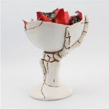 Load image into Gallery viewer, Gothic Skeleton Hand Storage Bowl by Allthingscurated boasts a spooky design featuring a ghoulish skeleton claw in neutral warm off-white and vivid hand bones encircling the bowl. Perfect for adding a frightful touch to your Halloween decor. Crafted from resin and measuring height of 13.5m or5.3 inches and width of 12cm or 4.7 inches.