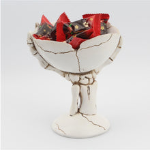Load image into Gallery viewer, Gothic Skeleton Hand Storage Bowl by Allthingscurated boasts a spooky design featuring a ghoulish skeleton claw in neutral warm off-white and vivid hand bones encircling the bowl. Perfect for adding a frightful touch to your Halloween decor. Crafted from resin and measuring height of 13.5m or5.3 inches and width of 12cm or 4.7 inches.