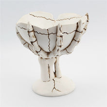 Load image into Gallery viewer, Gothic Skeleton Hand Storage Bowl by Allthingscurated boasts a spooky design featuring a ghoulish skeleton claw in neutral warm off-white and vivid hand bones encircling the bowl. Perfect for adding a frightful touch to your Halloween decor. Crafted from resin and measuring height of 13.5m or5.3 inches and width of 12cm or 4.7 inches.