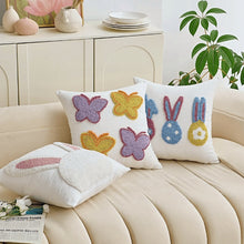 Load image into Gallery viewer, Decorative pillows with embroidered designs on a beige sofa. Spring Melody Embroidered Cushion Covers by Allthingscurated feature charming seasonal details to transition your home into Spring and Easter effortlessly. Each cover showcases meticulous embroidery to add depth and visual interest to your sofa and furniture.