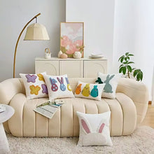 Load image into Gallery viewer, Beige sofa with colorful spring-themed cushions in a living room setting. Spring Melody Embroidered Cushion Covers by Allthingscurated feature charming seasonal details to transition your home into Spring and Easter effortlessly. Each cover showcases meticulous embroidery to add depth and visual interest to your sofa and furniture.