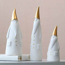 Load image into Gallery viewer, Not your typical jolly Santa Clauses with a plush red suit and rounded belly, this Nordic Santa Claus Figurines Set by Allthingscurated featured 3 porcelain figures of Santa Claus dressed in long white gown and a gold pointed hat. With subtle, understated elegance, they are perfect decoration to add to your Christmas collection to create an enchanting display. Figurines come in 3 different heights of 15cm, 20cm and 23cm or 6 inches, 7.8 inches and 9 inches.