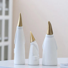 Load image into Gallery viewer, Not your typical jolly Santa Clauses with a plush red suit and rounded belly, this Nordic Santa Claus Figurines Set by Allthingscurated featured 3 porcelain figures of Santa Claus dressed in long white gown and a gold pointed hat. With subtle, understated elegance, they are perfect decoration to add to your Christmas collection to create an enchanting display. Figurines come in 3 different heights of 15cm, 20cm and 23cm or 6 inches, 7.8 inches and 9 inches.