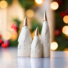 Load image into Gallery viewer, Not your typical jolly Santa Clauses with a plush red suit and rounded belly, this Nordic Santa Claus Figurines Set by Allthingscurated featured 3 porcelain figures of Santa Claus dressed in long white gown and a gold pointed hat. With subtle, understated elegance, they are perfect decoration to add to your Christmas collection to create an enchanting display. Figurines come in 3 different heights of 15cm, 20cm and 23cm or 6 inches, 7.8 inches and 9 inches.