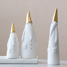 Load image into Gallery viewer, Not your typical jolly Santa Clauses with a plush red suit and rounded belly, this Nordic Santa Claus Figurines Set by Allthingscurated featured 3 porcelain figures of Santa Claus dressed in long white gown and a gold pointed hat. With subtle, understated elegance, they are perfect decoration to add to your Christmas collection to create an enchanting display. Figurines come in 3 different heights of 15cm, 20cm and 23cm or 6 inches, 7.8 inches and 9 inches.