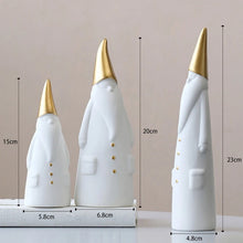 Load image into Gallery viewer, Not your typical jolly Santa Clauses with a plush red suit and rounded belly, this Nordic Santa Claus Figurines Set by Allthingscurated featured 3 porcelain figures of Santa Claus dressed in long white gown and a gold pointed hat. With subtle, understated elegance, they are perfect decoration to add to your Christmas collection to create an enchanting display. Figurines come in 3 different heights of 15cm, 20cm and 23cm or 6 inches, 7.8 inches and 9 inches.