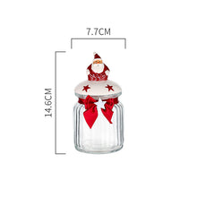 Load image into Gallery viewer, Christmas Festive Storage Jars by Allthingscurated are the perfect jars to keep all your festive treats fresh and delicious. The jars are airtight and each jar is topped with a ceramic lid decorated with a Santa Claus, Christmas Tree, Penguin, Gnome or Fox. Comes in 2 sizes with capacity of 300ml or 10 ounce and 1000ml or 34 ounce. Featured here is a small Santa Claus jar.