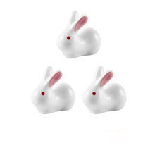 Load image into Gallery viewer, Enhance your Asian dining experience with our Ceramic Rabbit Chopstick Rests by Allthingscurated. These pieces will bring a playful edge to your table with their ability to keep your chopsticks clean and secure. This is a set of 3 pieces.