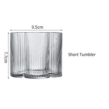 Load image into Gallery viewer, Florentina Drinkware by Allthingscurated embraces a modern design featuring sleek fluted lines with a unique shape reminiscent of a peach blossom flower. Stylish and chic, this collection includes a carafe, goblets and several tumblers, including a glamorous coupe cocktail glass. Add elegance to everyday use with this beautiful collection and just as perfect for setting an extravagant holiday table. Seen here is a Short Tumbler.