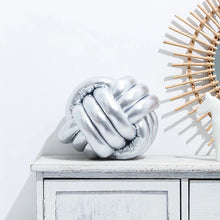 Load image into Gallery viewer, Metallic Color Knot Ball Cushions by Allthingscurated come in a metallic palette of Gold, Silver and Red. These cushions will give your home a trendy update easily with their bold design and bring attention to your favorite sofa or chair. Their unique spherical shape and eye-catching colors will add a stylish and sculptural touch to your living space.