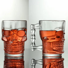 Load image into Gallery viewer, Skull Beer Mug by Allthingscurated blends functionality with style. Made with thickened glass with a heavy bottom for stability, it spots a fun, cool skull shape design that is ideal for Halloween or everyday use. The large capacity is perfect for beer or any beverage. Add this must-have mug to your drinkware collection and be ready for any gatherings or house parties.