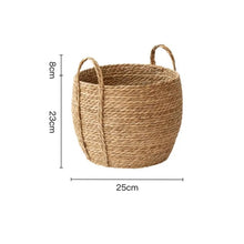 Load image into Gallery viewer, Leedon Woven Baskets by Allthingscurated are hand-woven from seagrass which is an eco-friendly material. The baskets feature sturdy handles for easy transportation and lend a rustic charm to any space. Perfect for storing household items or displaying your favorite plants. Available in 3 sizes. Featured here is the small basket measuring 23cm or 9 inches in height and 25cm or 9.8 inches in width.