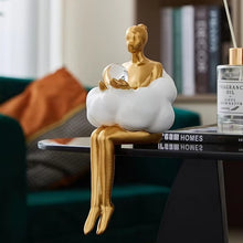 Load image into Gallery viewer, Sophie Cloud Girl Sculptures by Allthingscurated feature 2 beautiful lady statues in 2 postures—reading and pondering. Adorned with a classic ballerina bun and dressed in a minimalistic dress that ends with a voluminous skirt reminiscent of fluffy clouds. These sculptures bring a touch of serenity and sophistication to your living space.