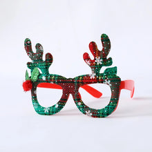 Load image into Gallery viewer, Antler Christmas Party Glasses by Allthingscurated are the perfect fun accessory for festive parties and gatherings during the holiday season. Their unique design and cheerful holiday style make them great props for creating memorable moments an happy Instagram posts to capture the joy of the season. Featured here is the Tartan Antler in  red and green, snowflake-speckled tartan design.