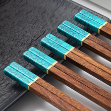 Load image into Gallery viewer, Faux Jade Wooden Chopsticks by Allthingscurated feature five striking colors with jade embellishment crafted from high-grade resin that is contemporary in design yet practical in everyday dining or special occasions. Come as a set of 5 pairs or 10 pairs. Shown here is a set in Turqoise.
