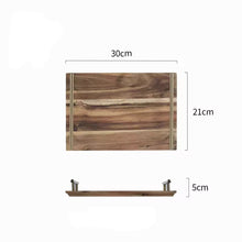 Load image into Gallery viewer, Wooden Serving Tray by Allthingscurated is designed with versatility and organic beauty in mind. Crafted from natural wood and accented with gold hardware handles for easy transportation and handling, these wooden trays serve up your sliced breads, cheeses and drinks in style. With 3 size options, they are ideal for hosting and a nice presentation with a natural touch to your table. Shown here is the small tray measuring 30cm or 11.7 inches in width, 21cm or 8 inches in depth and 5cm or 2inches in height.