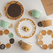 Load image into Gallery viewer, The Waffle Cup and Plate collection by Allthingscurated features a charming waffle pattern and whimsical biscuit design that will bring a smile to your breakfast. Each piece is hand painted on porcelain. Perfect for breakfast and tea time. Makes a great gift for any occasion. Cup and plate each comes in 4 designs to choose from.