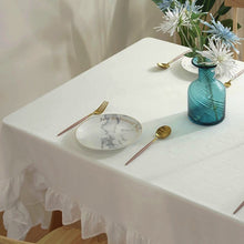 Load image into Gallery viewer, Introducing Ruffled Cotton Tablecloth by Allthingscurated. Made from 100% cotton, our tablecloth exudes French country charm with its romantic, frilly ruffles. With the perfect balance of decorative and laid-back, they have a welcoming and comforting vibe. Available in 8 solid colors.
