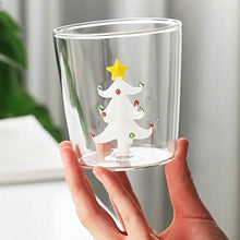 Load image into Gallery viewer, Christmas Tree Drinking Glass by Allthingscurated has a playful and whimsical design, featuring a sculptural 3D Christmas Tree within the tumbler. The tree comes in a 2 colors, green and white. Measuring 8.5cm or 3.3 inches in width at the top, 9cm or 3.5 inches in height and 6.5cm or 2.5 inches in width at the base, the drinking glass has a capacity of 300ml or 10 ounce. Featured here is one with a white Christmas Tree.