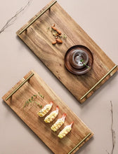 Load image into Gallery viewer, Wooden Serving Tray by Allthingscurated is designed with versatility and organic beauty in mind. Crafted from natural wood and accented with gold hardware handles for easy transportation and handling, these wooden trays serve up your sliced breads, cheeses and drinks in style. With 3 size options, they are ideal for hosting and a nice presentation with a natural touch to your table.